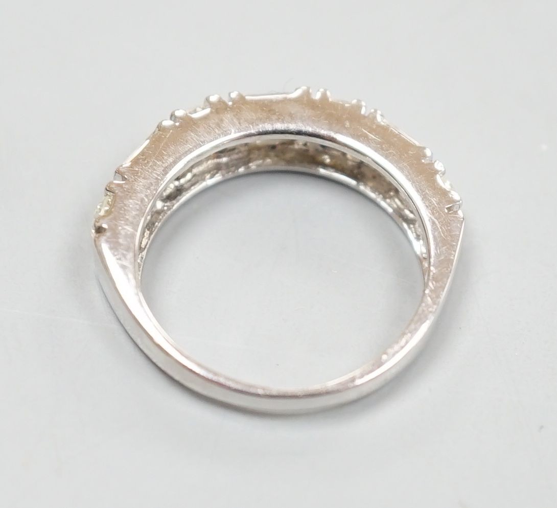 A modern 14ct gold, baguette and round cut diamond set half hoop ring, size K, gross weight 3.9 grams.
